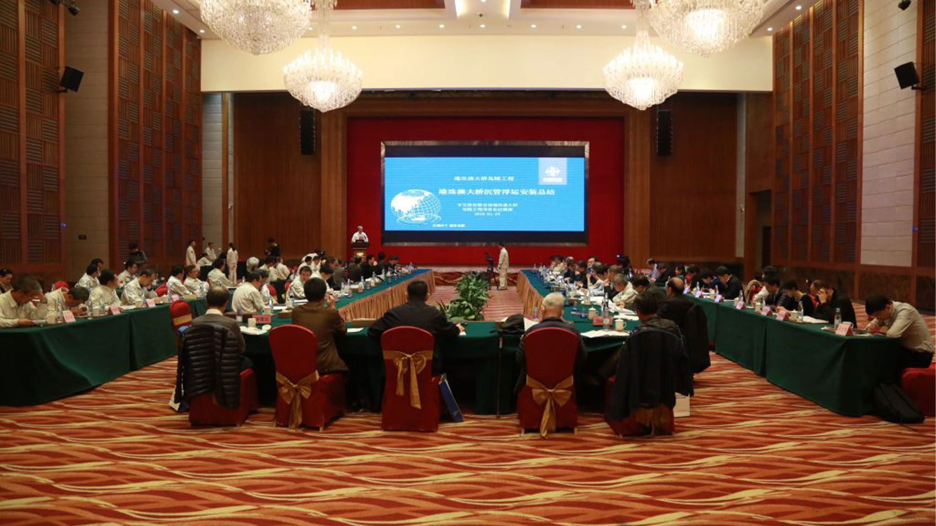 event room full of people watching a presentation