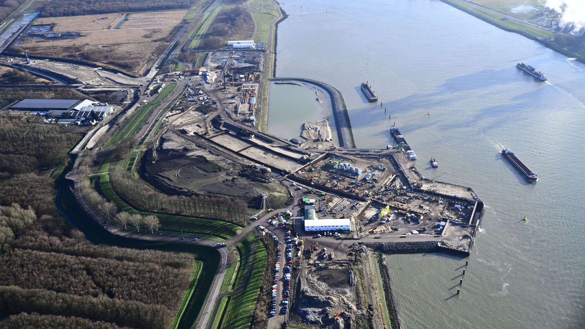 big river with construction taking place next to it